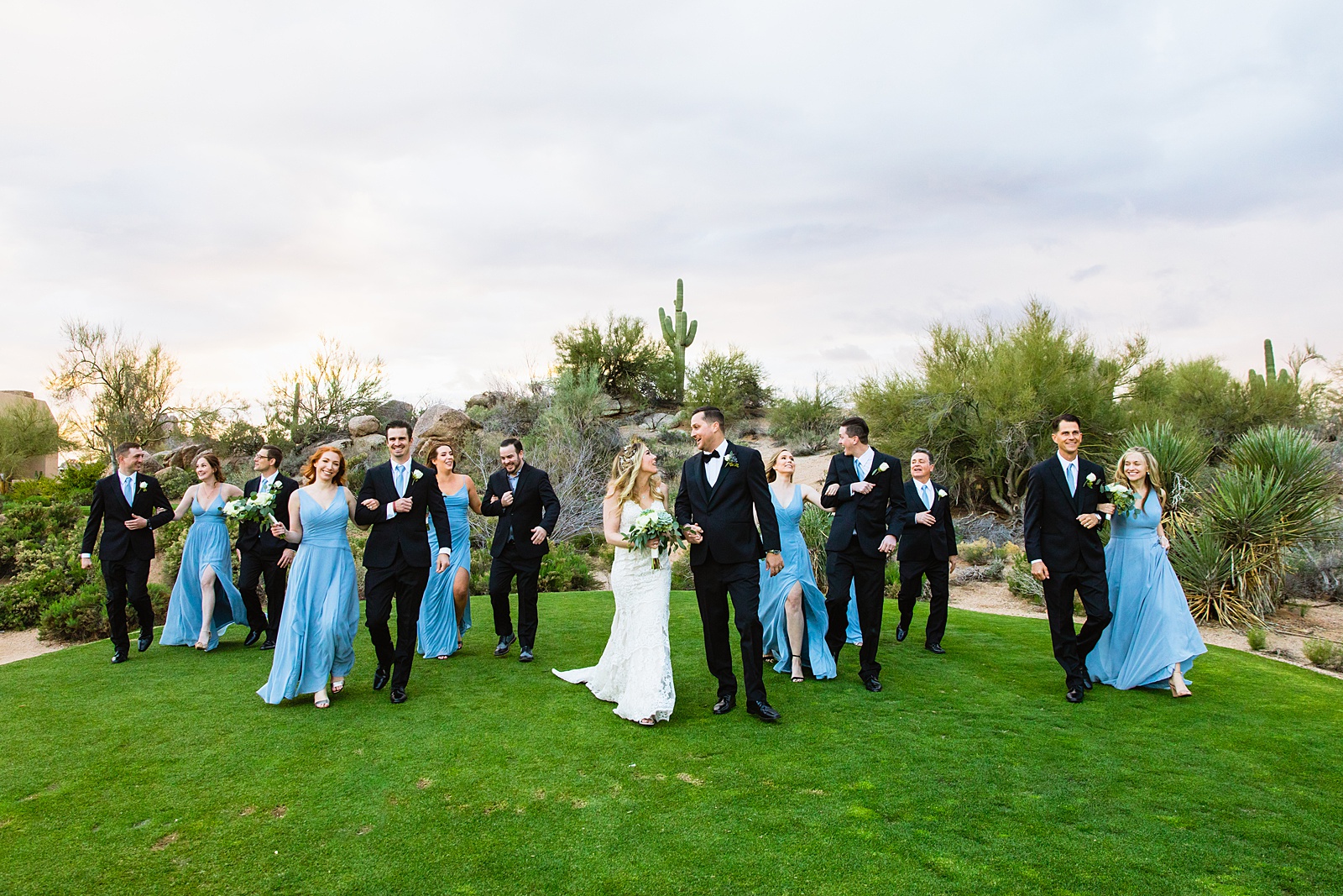 Bridal party walking together at a Troon North wedding by Arizona wedding photographer PMA Photography.