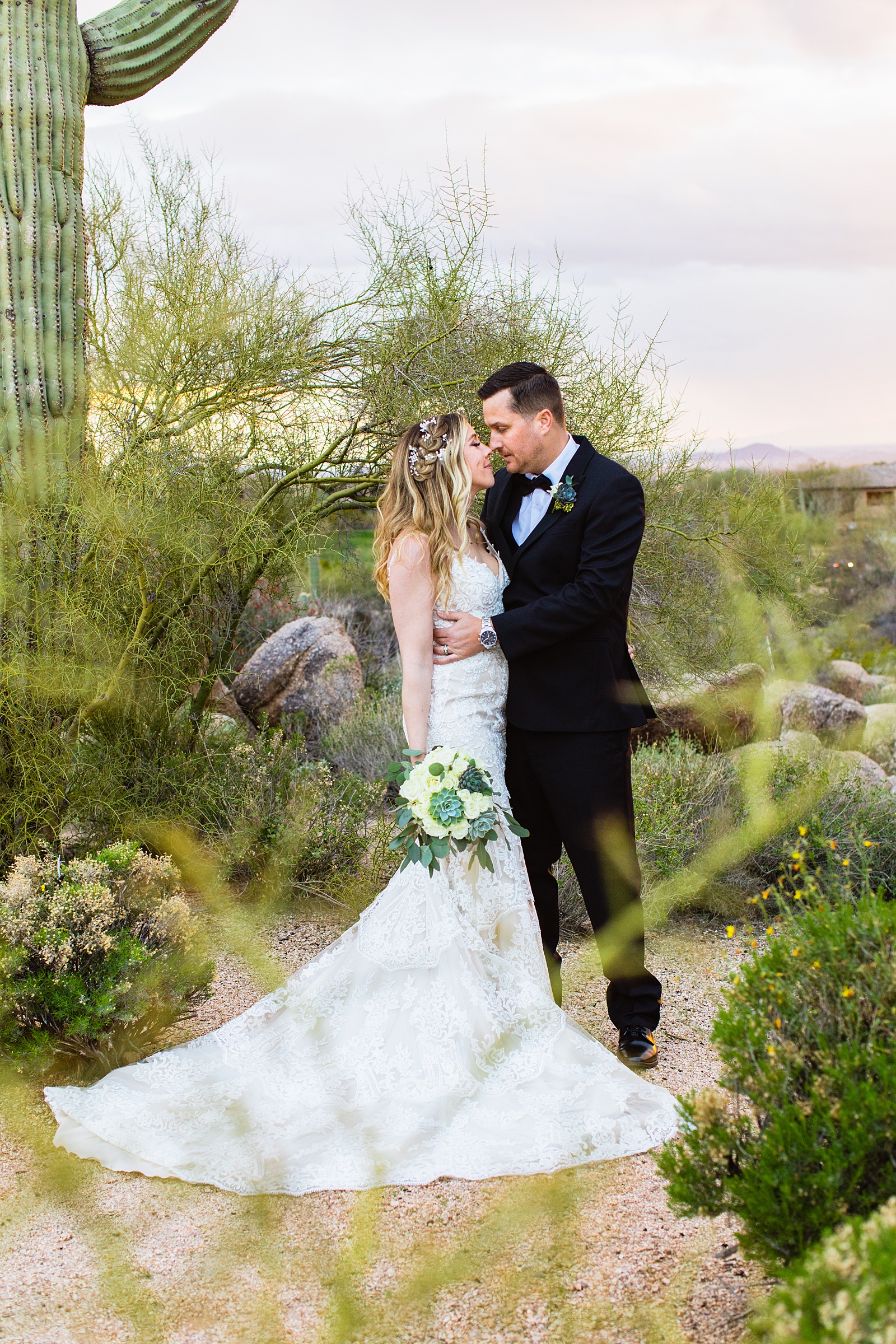Newlyweds share an intimate moment during their Troon North wedding by Scottsdale wedding photographer PMA Photography.