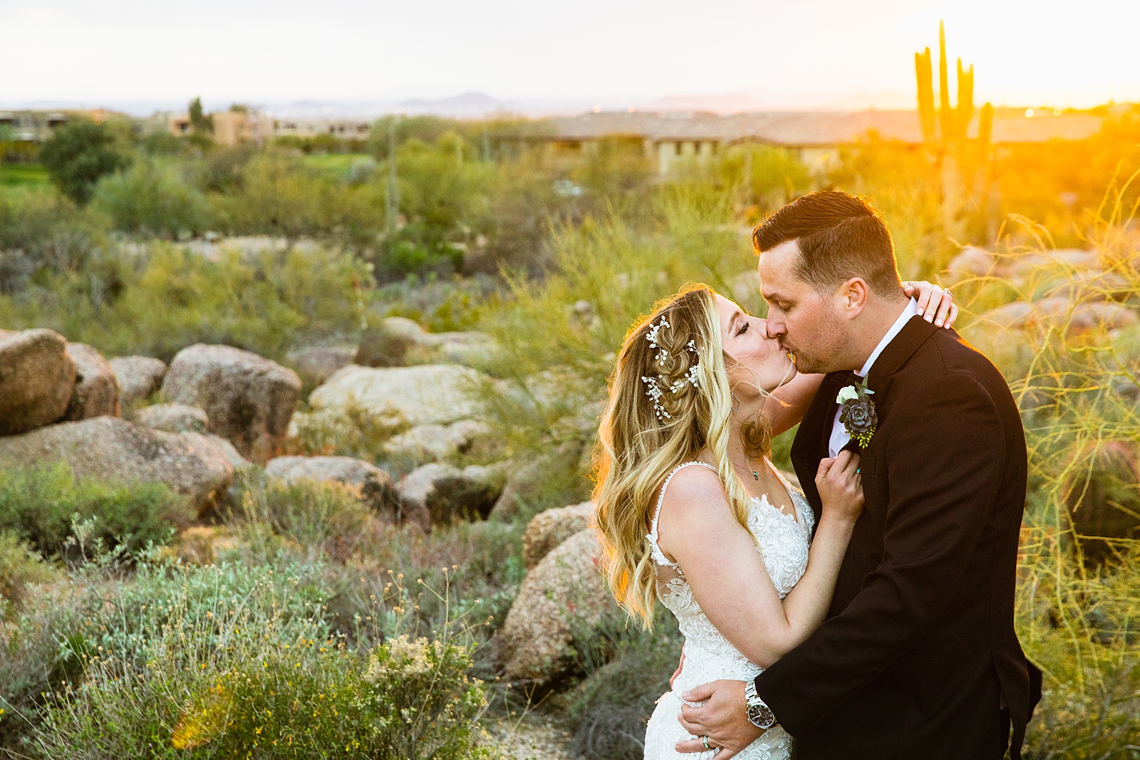 Newlyweds share a kiss during their Troon North wedding by Scottsdale wedding photographer PMA Photography.