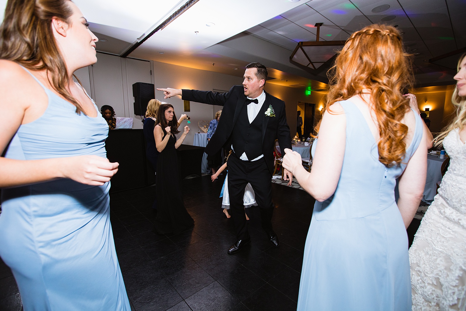 Groom dancing with guests at Troon North wedding reception by Scottsdale wedding photographer PMA Photography