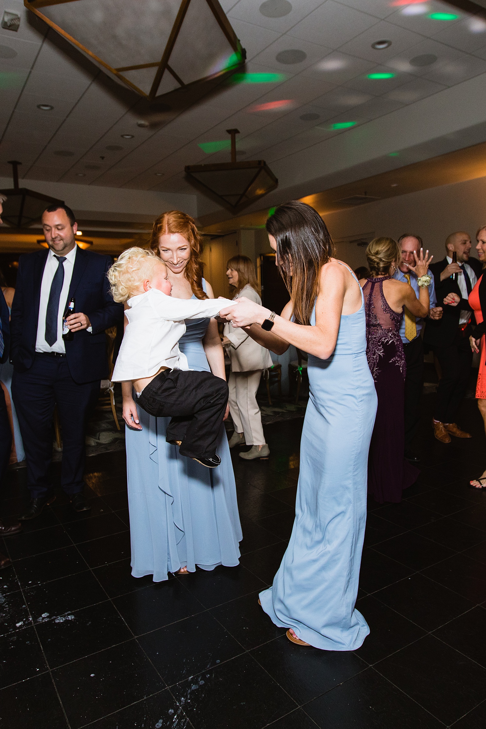 Guests dancing together at Troon North wedding reception by Scottsdale wedding photographer PMA Photography