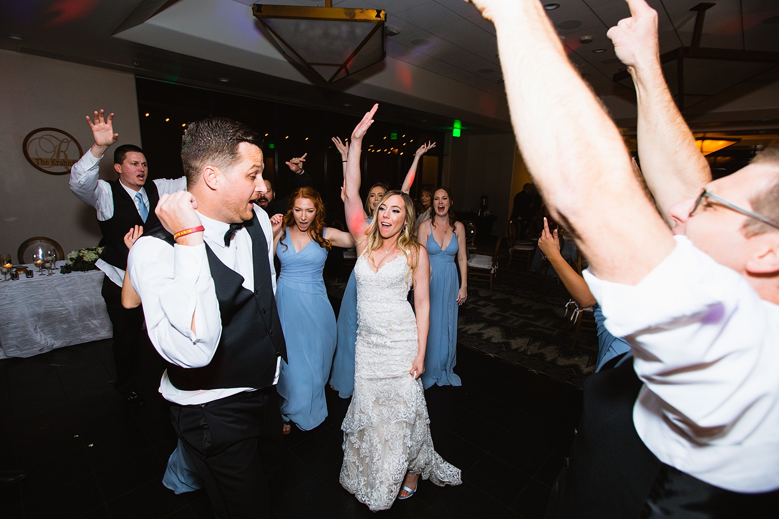 Newlyweds dancing with guests at their Troon North wedding reception by Arizona wedding photographer PMA Photography
