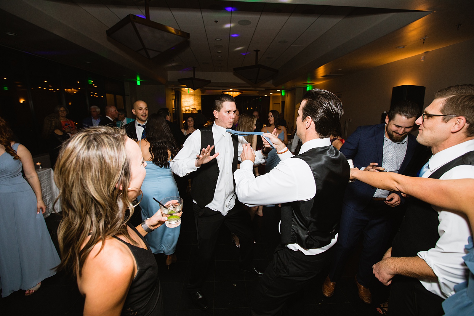 Guests dancing together at Troon North wedding reception by Scottsdale wedding photographer PMA Photography