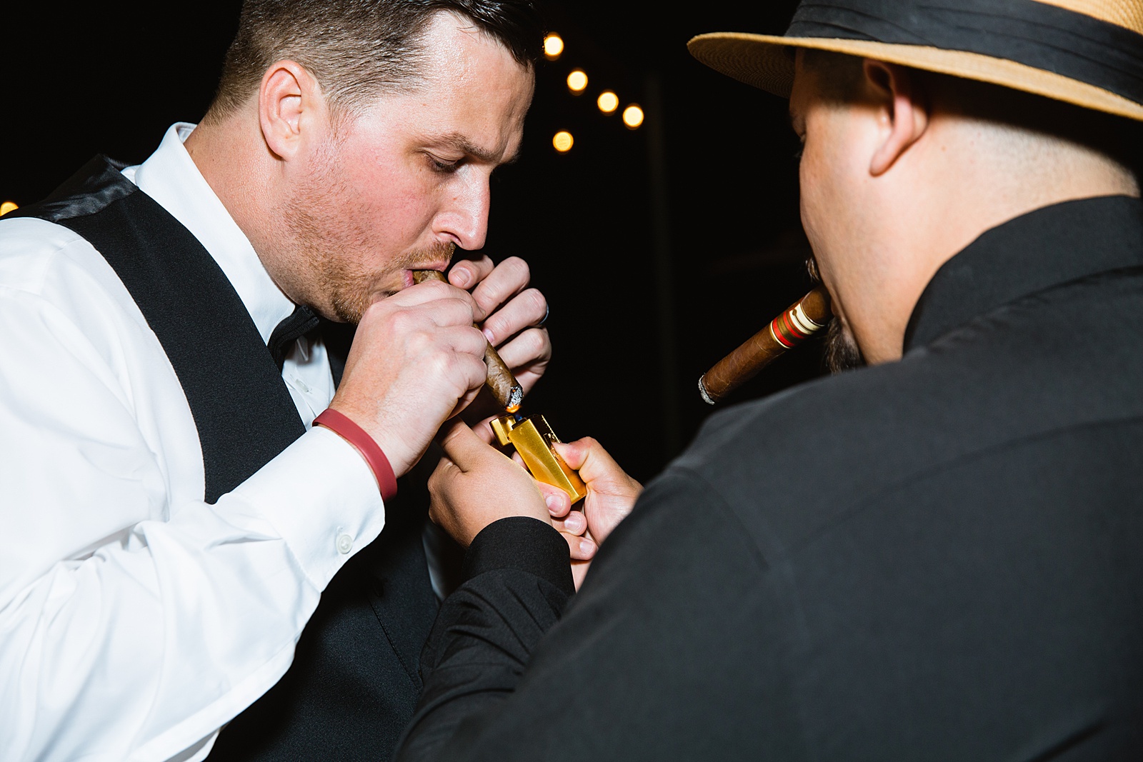 Groom smoking a cigar at a Troon North wedding by Scottsdale wedding photographer PMA Photography.