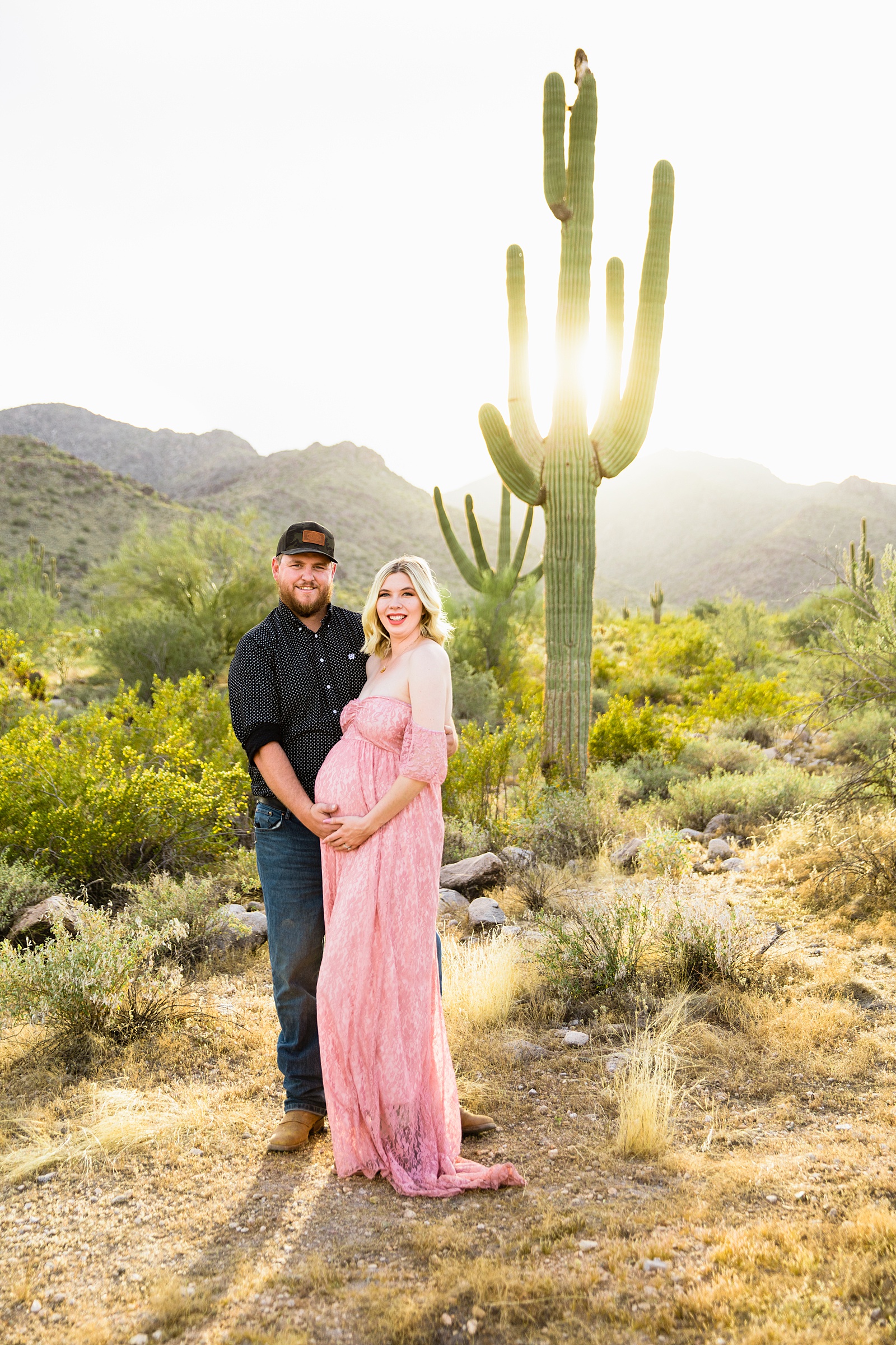 Couple pose for their White Tanks Desert maternity session by Phoenix maternity photographer PMA Photography.