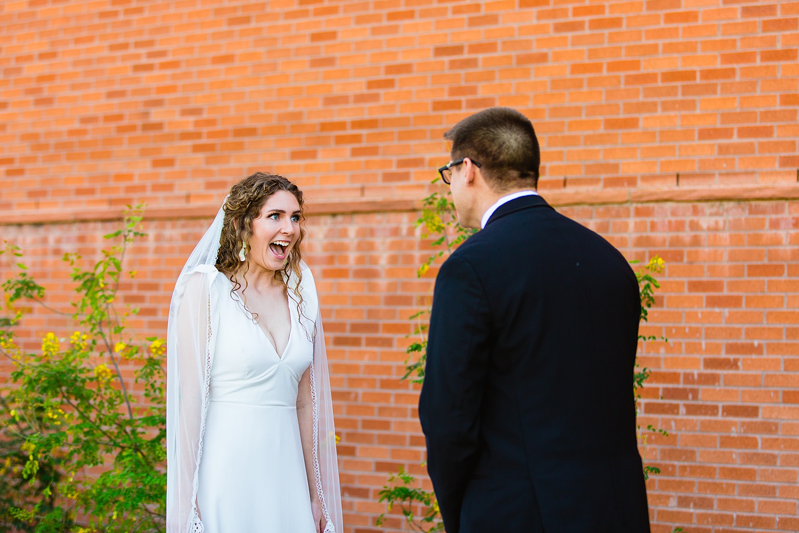 Bride and groom's first look at Arizona Historical Society by Tempe wedding photographer PMA Photography.