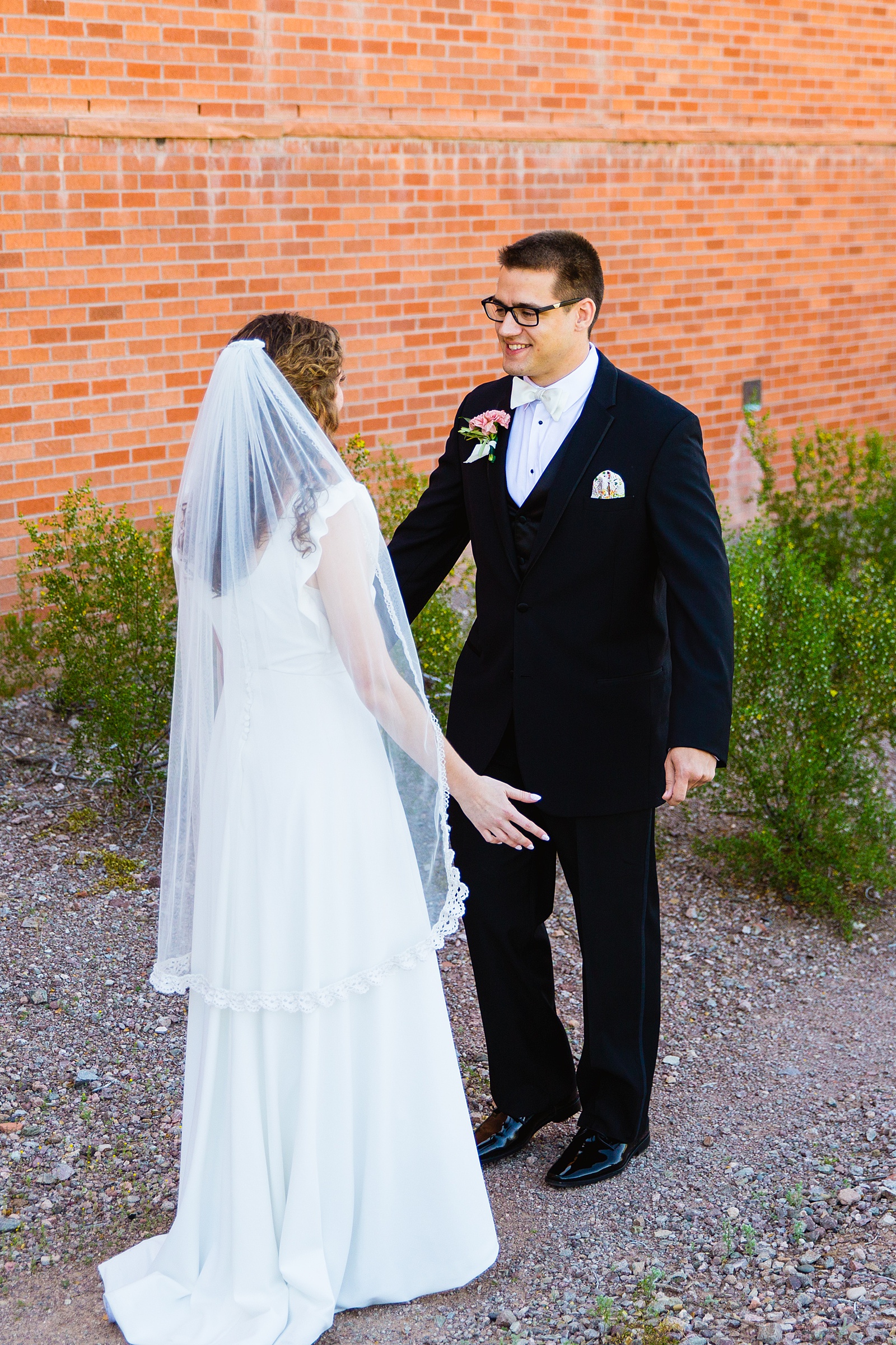 Bride and groom's first look at Arizona Historical Society by Phoenix wedding photographer PMA Photography.