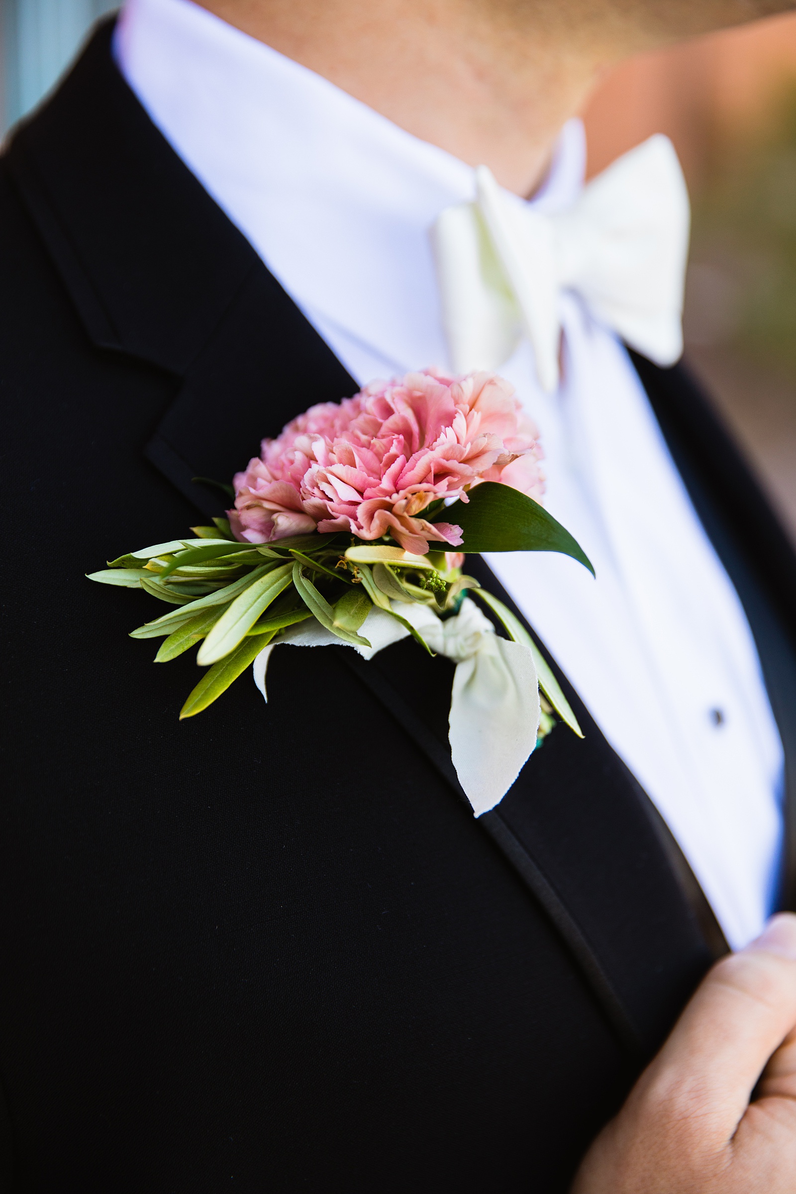 Groom's wedding day details of his boutonniere by PMA Photography.