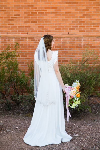 Bride's handmade (by herself) wedding dress and vibrant bouquet for her Arizona Historical Society wedding by PMA Photography.