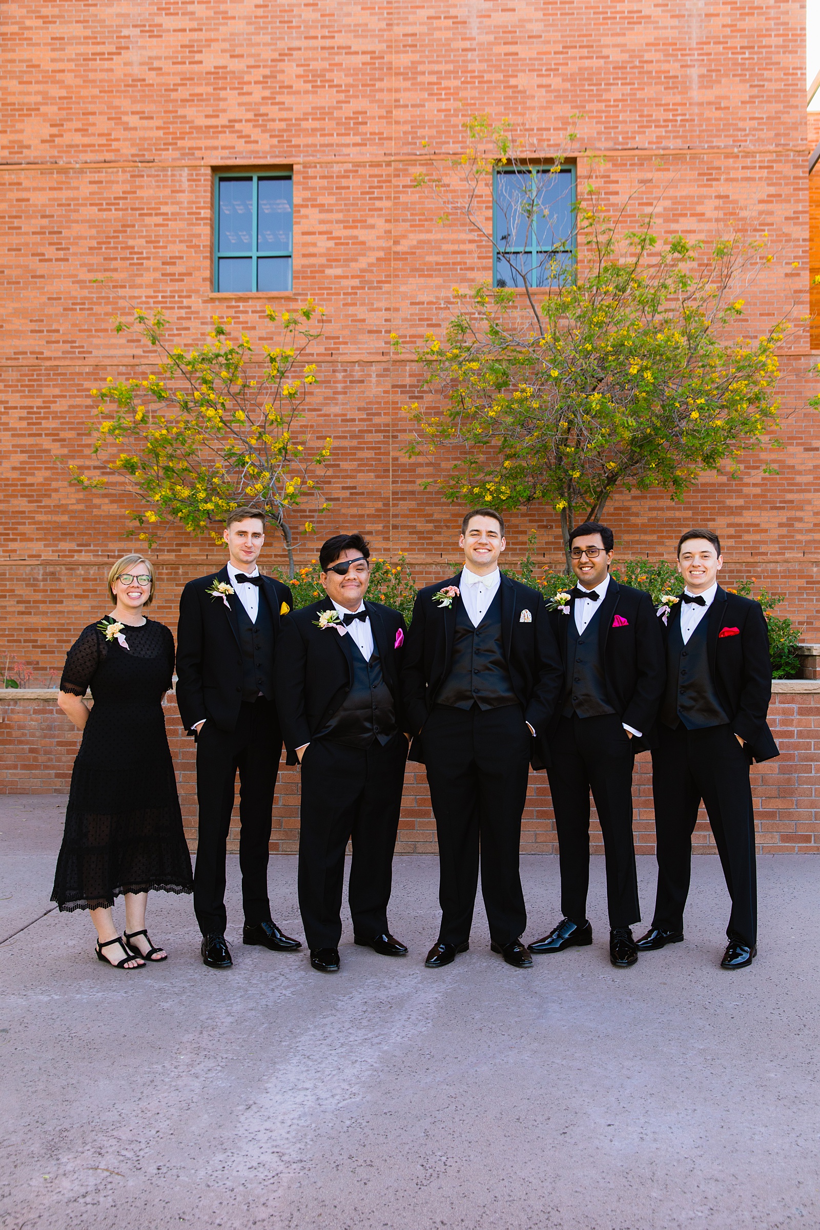 Groom and mixed gender bridal party together at a Arizona Historical Society wedding by Arizona wedding photographer PMA Photography.