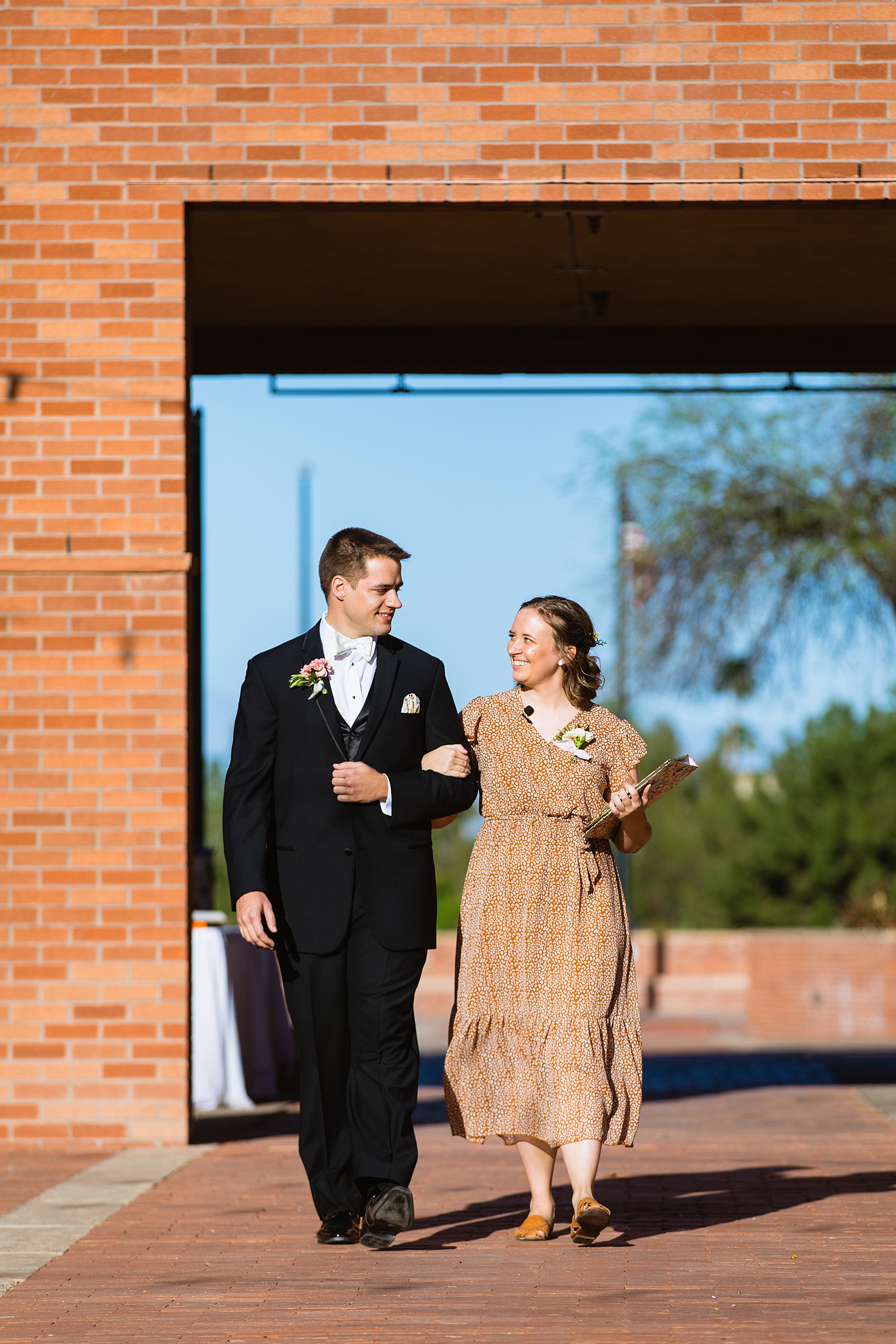 Groom walking down aisle during Arizona Historical Society wedding ceremony by Phoenix wedding photographer PMA Photography.