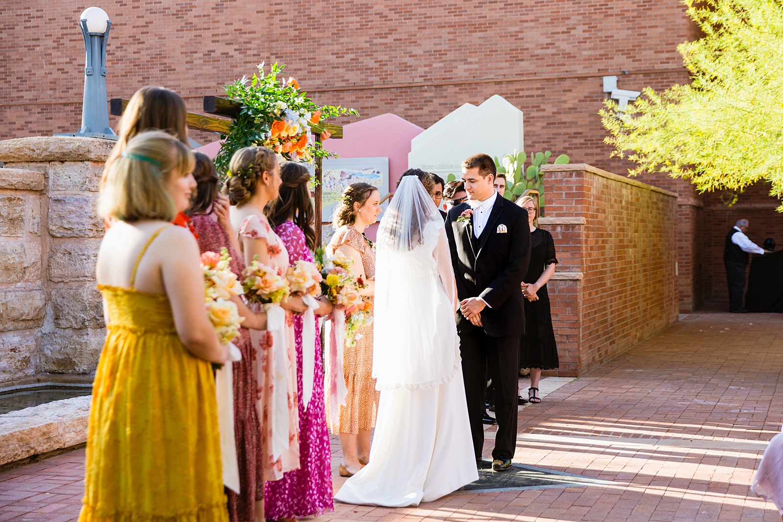 Groom looking at his bride during their wedding ceremony at Arizona Historical Society by Tempe wedding photographer PMA Photography.