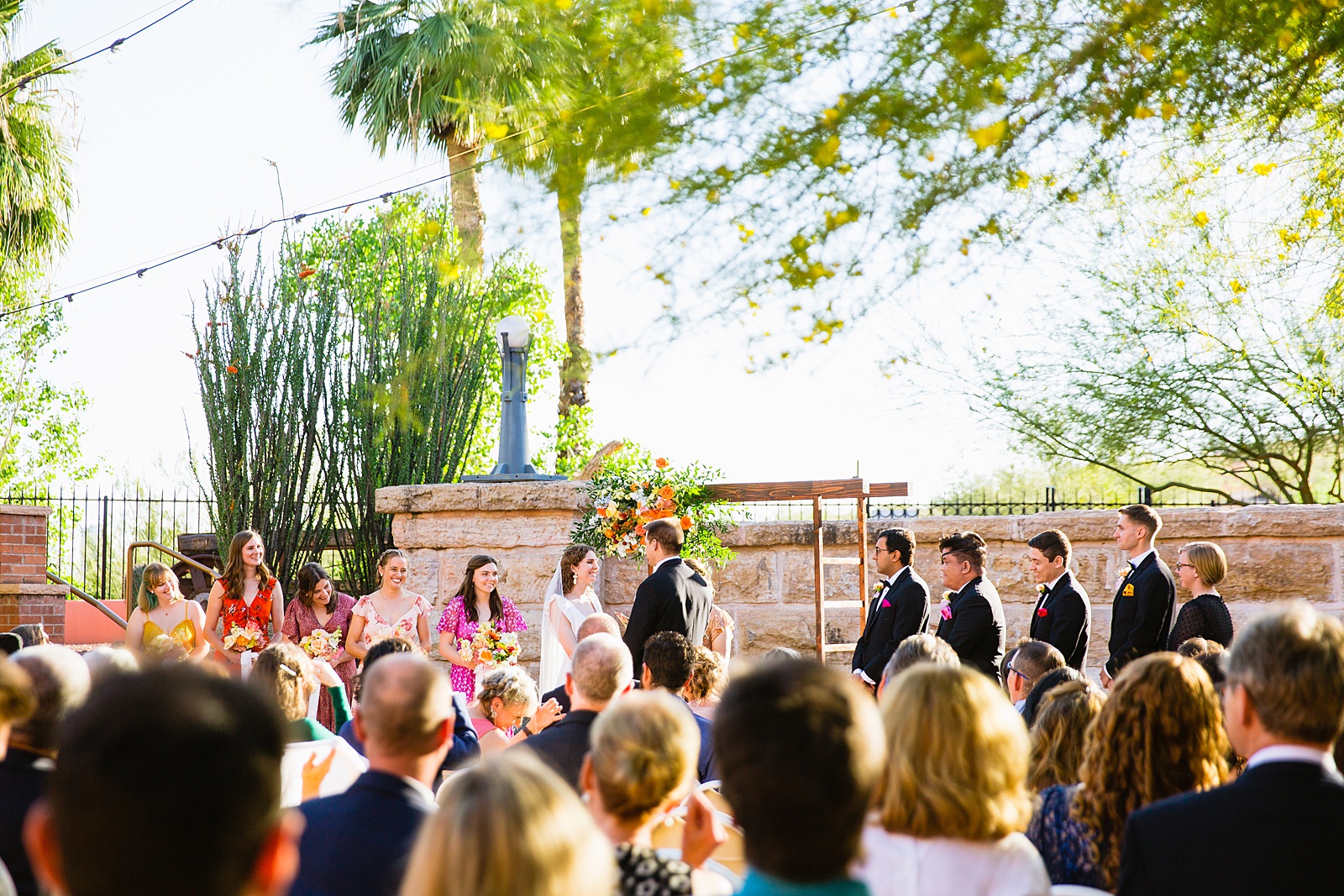 Bride looking at her groom during their wedding ceremony at Arizona Historical Society by Tempe wedding photographer PMA Photography.