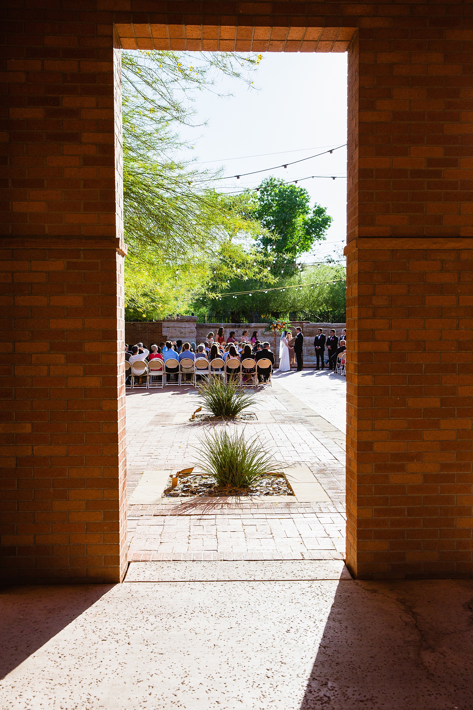 Wedding guests watching the wedding ceremony at Arizona Historical Society by Tempe wedding photographer PMA Photography.