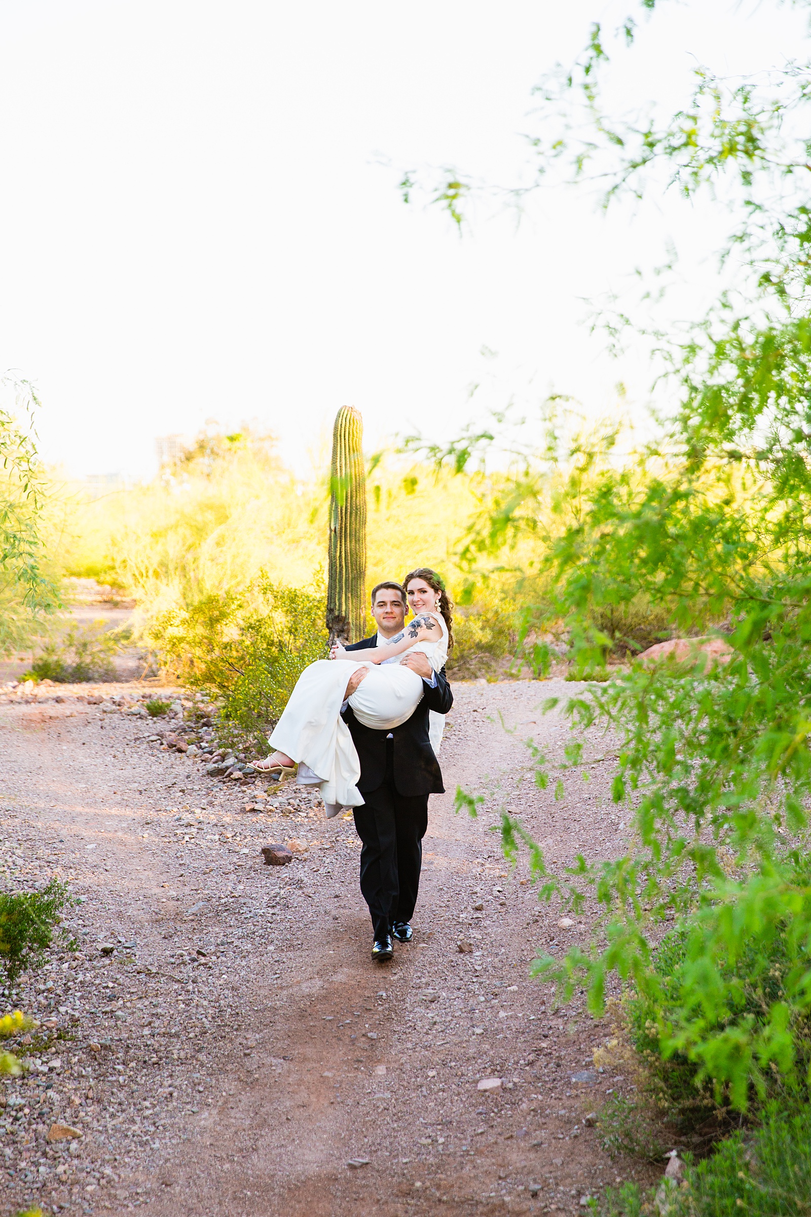 Bride and groom pose during their Arizona Historical Society wedding by Arizona wedding photographer PMA Photography.