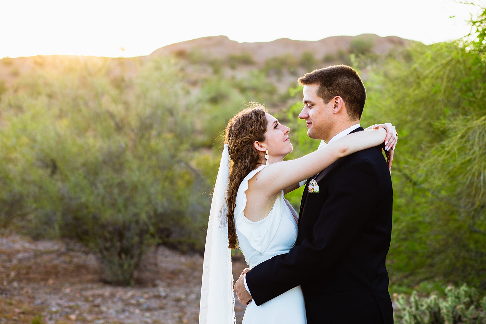 Bride and groom looking at each other during their Arizona Historical Society wedding by Tempe wedding photographer PMA Photography.