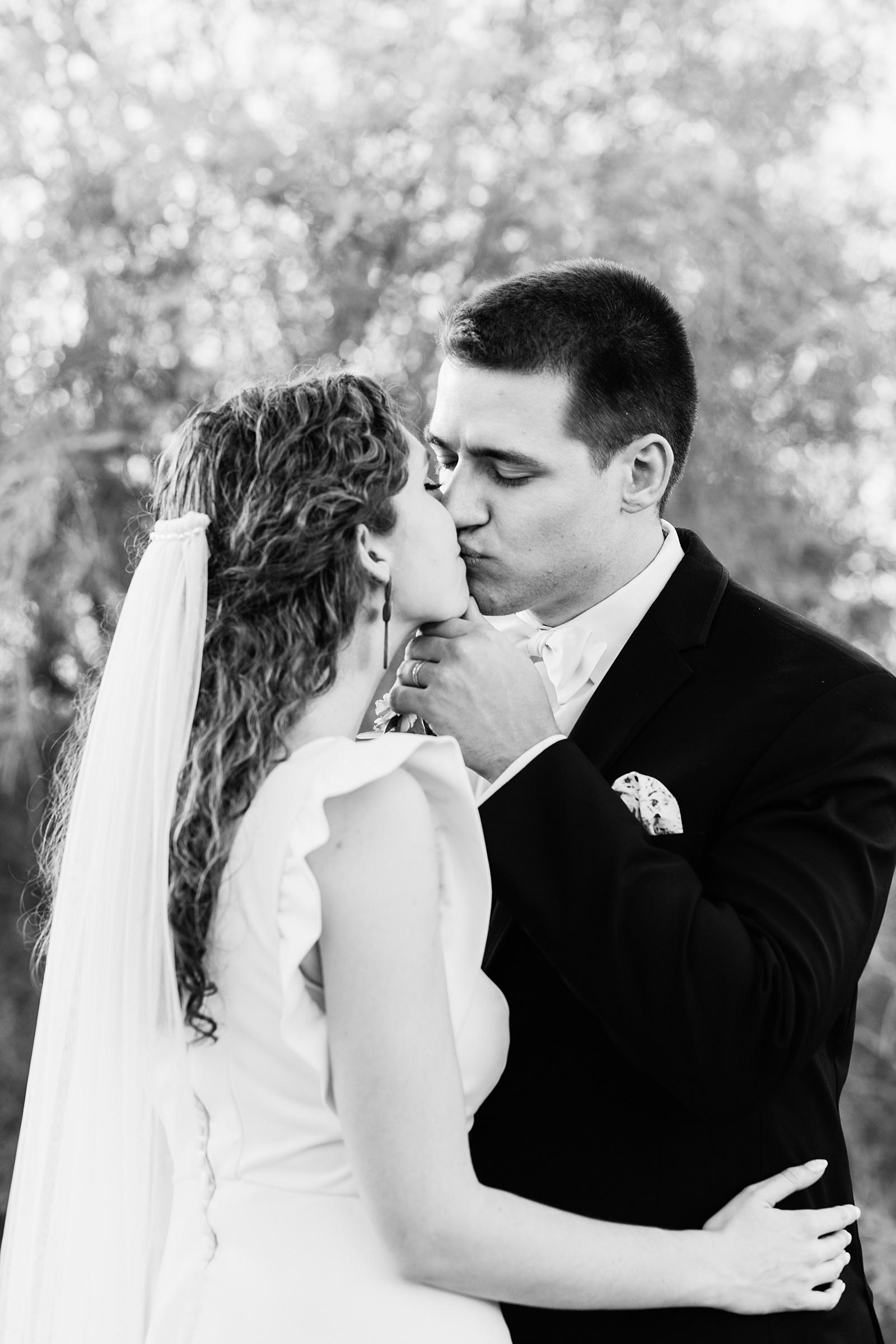 Bride and groom share a kiss during their Arizona Historical Society wedding by Arizona wedding photographer PMA Photography.