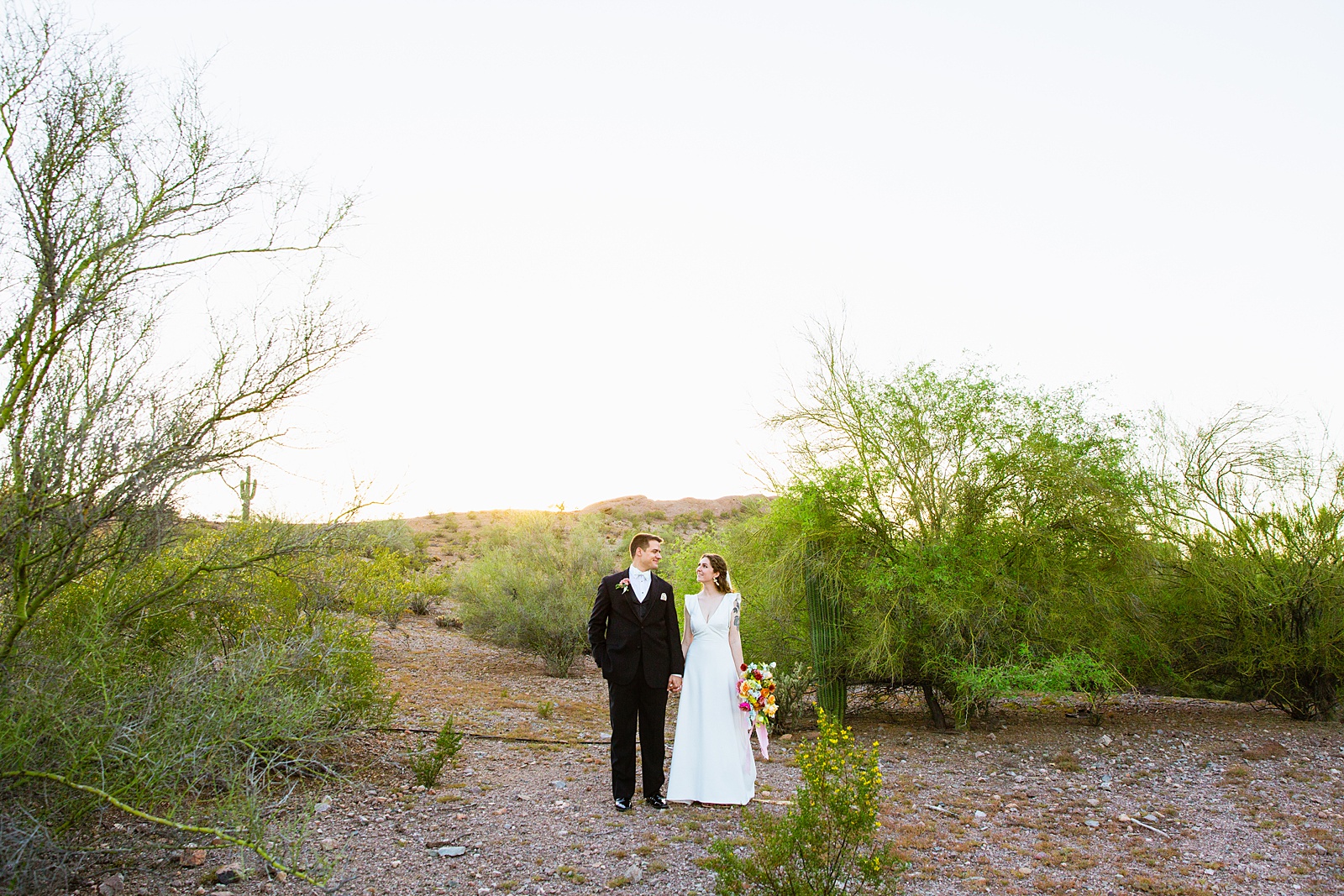 Bride and groom pose for their Arizona Historical Society wedding by Tempe wedding photographer PMA Photography.
