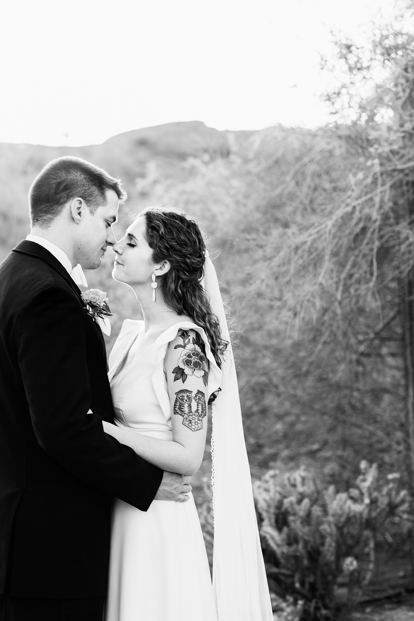 Bride and groom share a kiss during their Arizona Historical Society wedding by Arizona wedding photographer PMA Photography.