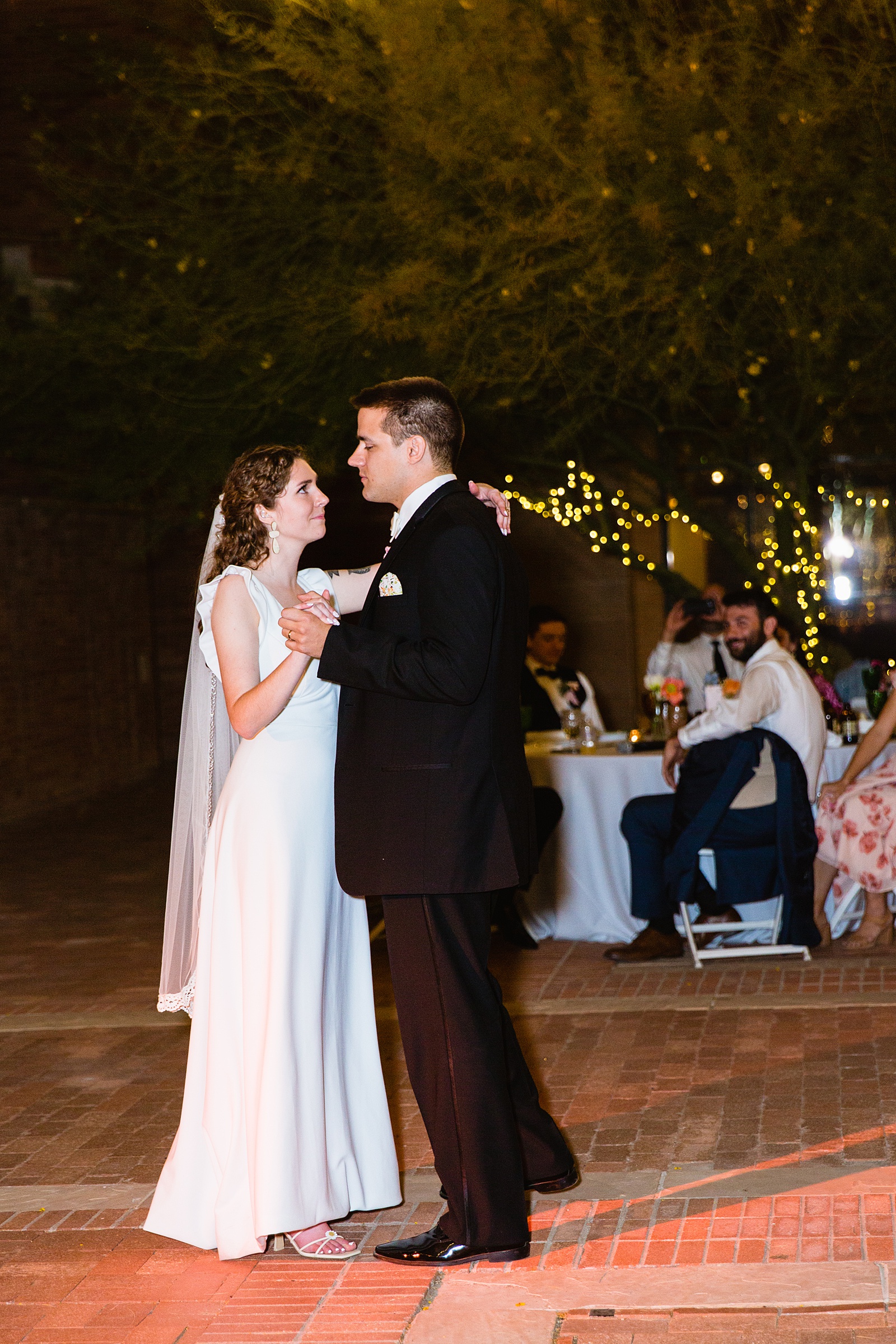 Bride and groom sharing first dance at their Arizona Historical Society wedding reception by Arizona wedding photographer PMA Photography.