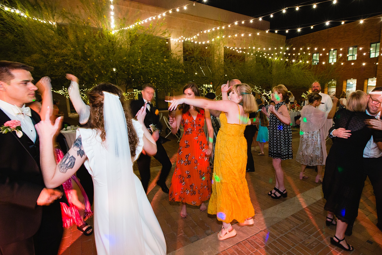 Guests dancing together at Arizona Historical Society wedding reception by Tempe wedding photographer PMA Photography