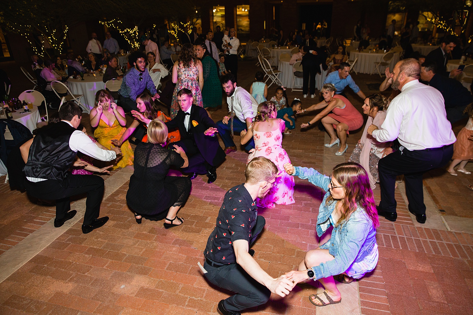Guests dancing together at Arizona Historical Society wedding reception by Tempe wedding photographer PMA Photography