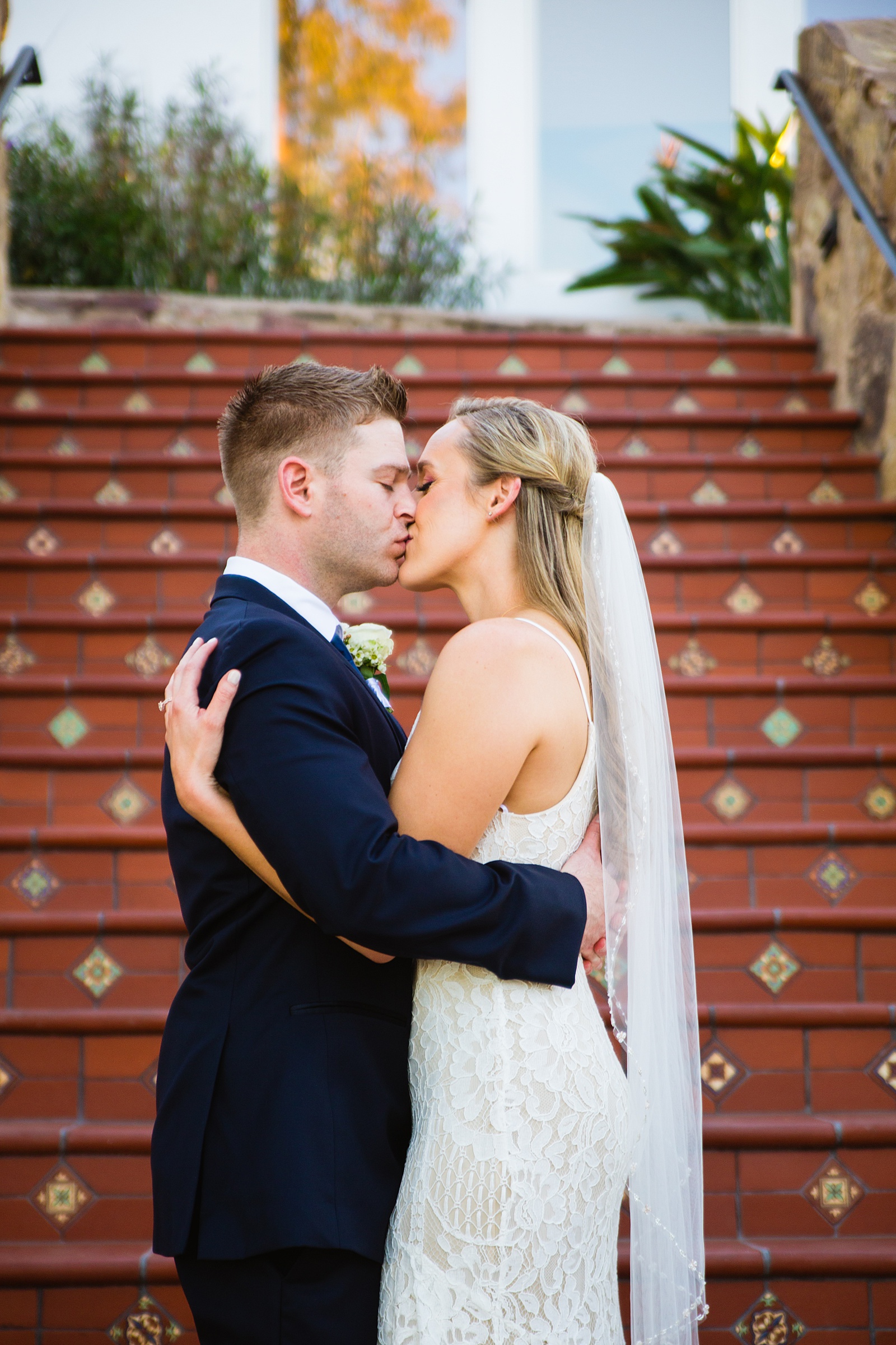 Bride and Groom share a kiss during their Wrigley Mansion wedding by Arizona wedding photographer PMA Photography.