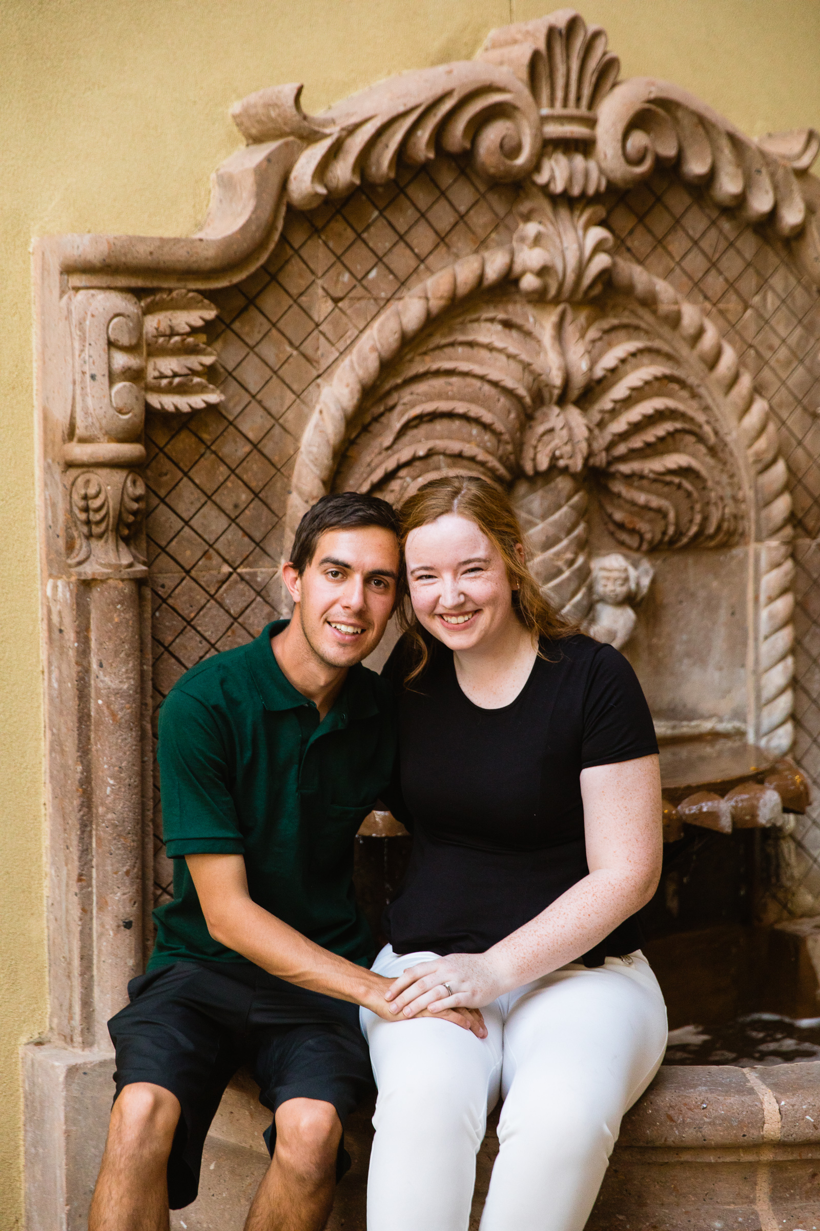 Parents pose together during their downtown family session by Verrado family photographer PMA Photography.