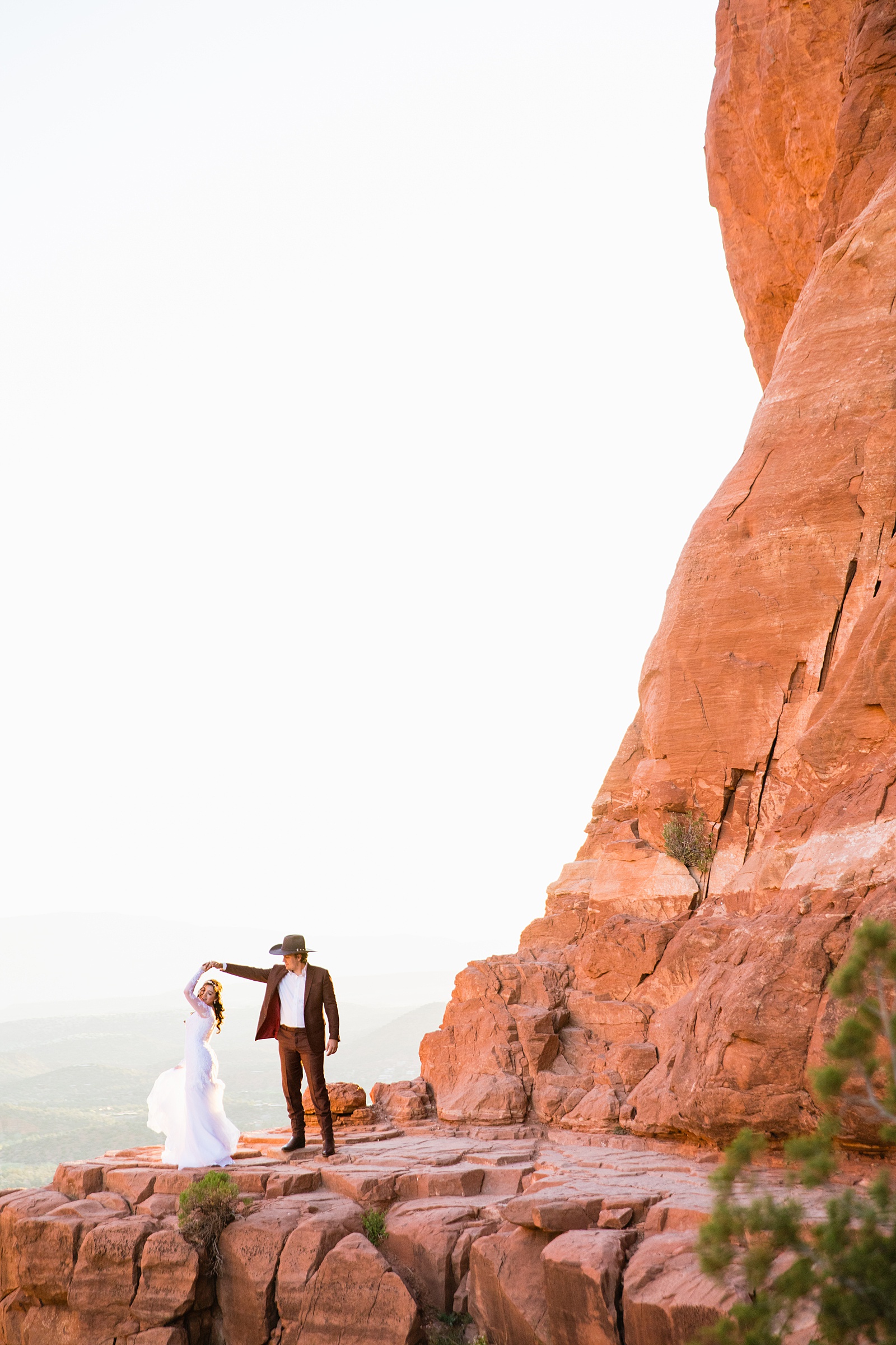 Bride and Groom dancing together during their Cathedral Rock elopement by Sedona elopement photographer PMA Photography.