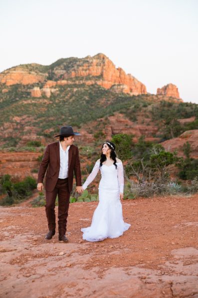 Bride and Groom walking together during their Cathedral Rock elopement by Arizona elopement photographer PMA Photography.