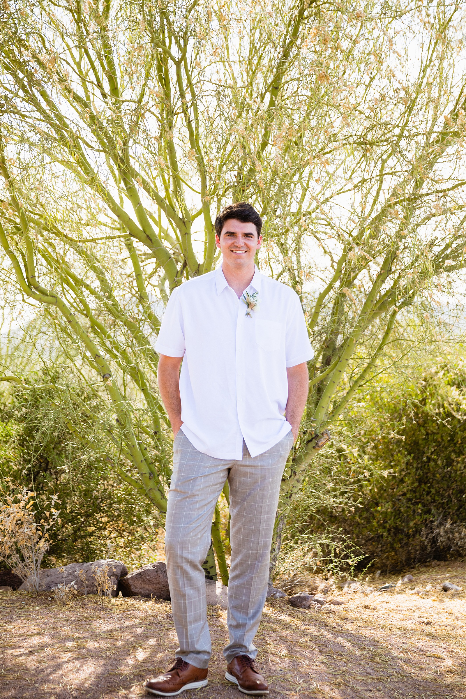 Groom's casual white button up and grey dress pants for his summer Superstition Mountain Micro wedding by PMA Photography.