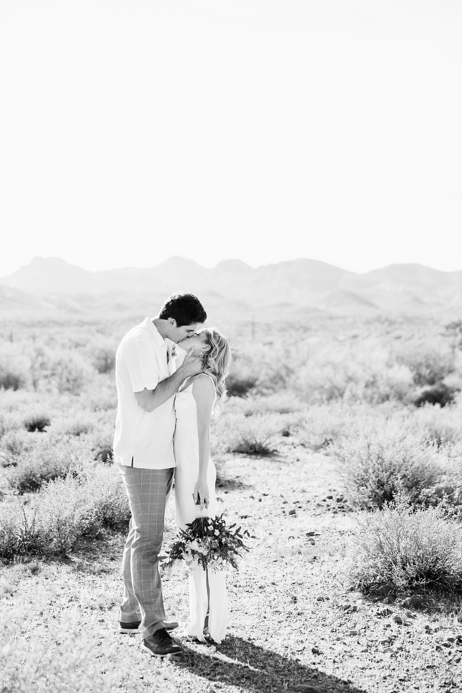 Bride and Groom share a kiss during their Superstition Mountain Micro wedding by Arizona wedding photographer PMA Photography.
