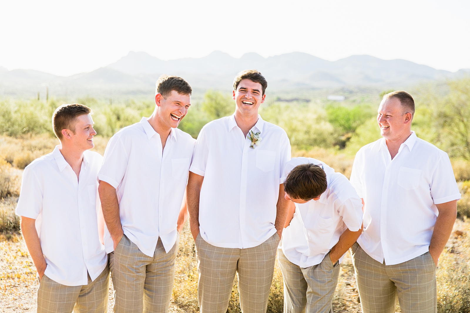 Groom and groomsmen laughing together at Superstition Mountain Micro wedding by Lost Dutchman wedding photographer PMA Photography.