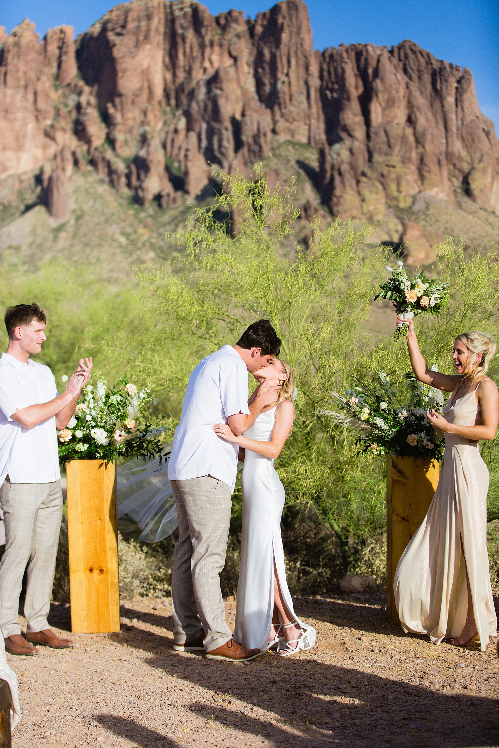 Bride and Groom share their first kiss during their wedding ceremony at Superstition Mountain Micro by Arizona wedding photographer PMA Photography.