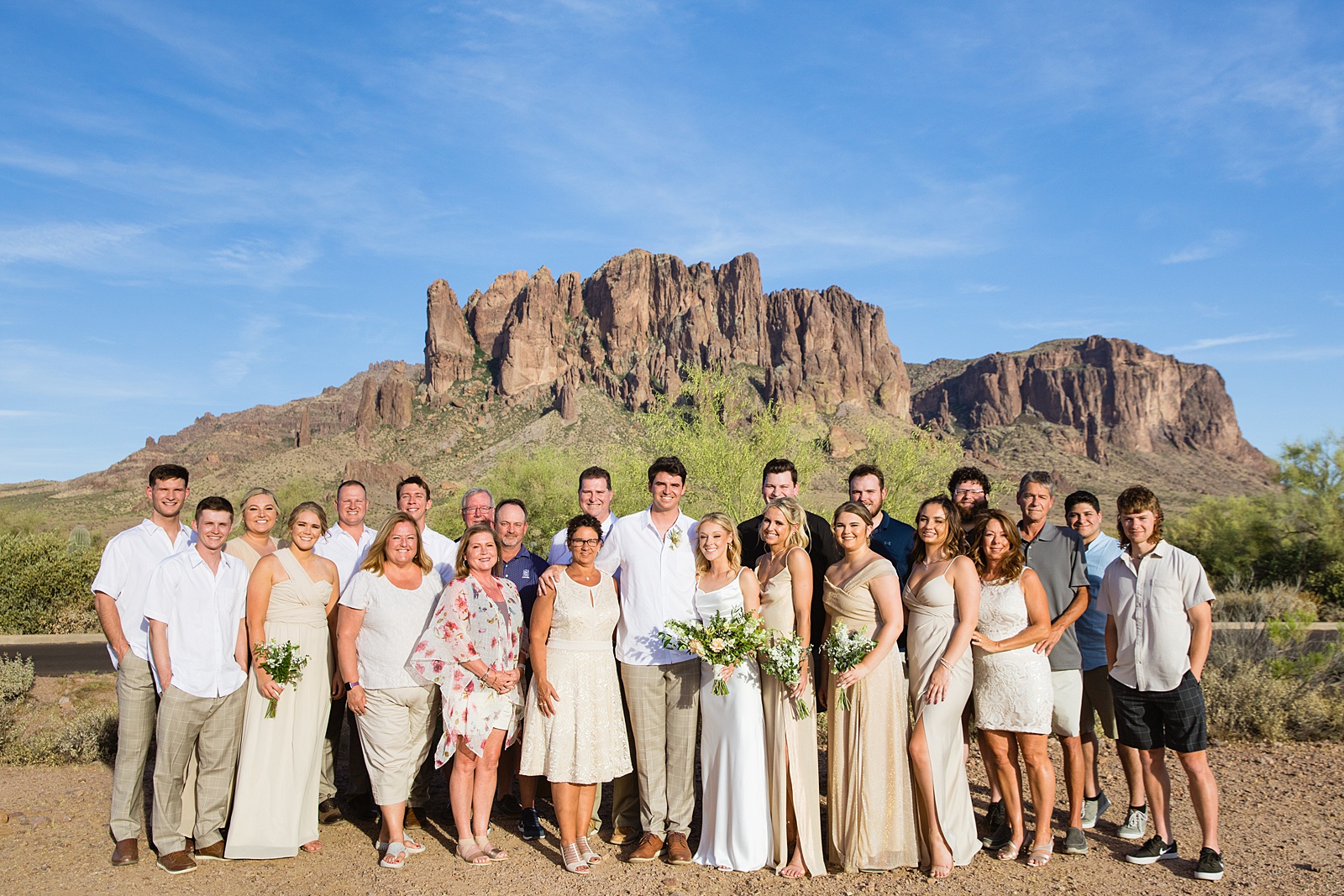 All the wedding guests pose with the bride and groom during their Superstition Mountain micro wedding by Arizona wedding photographer PMA Photography.