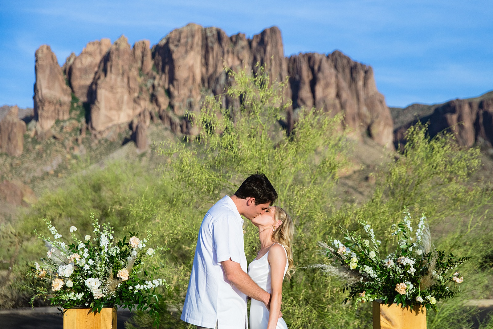 Bride and Groom share a kiss during their Superstition Mountain Micro wedding by Lost Dutchman wedding photographer PMA Photography.