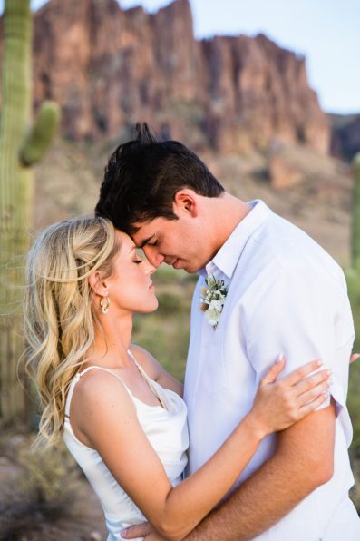Bride and groom share an intimate moment at their Superstition Mountain Micro wedding by Arizona wedding photographer PMA Photography.