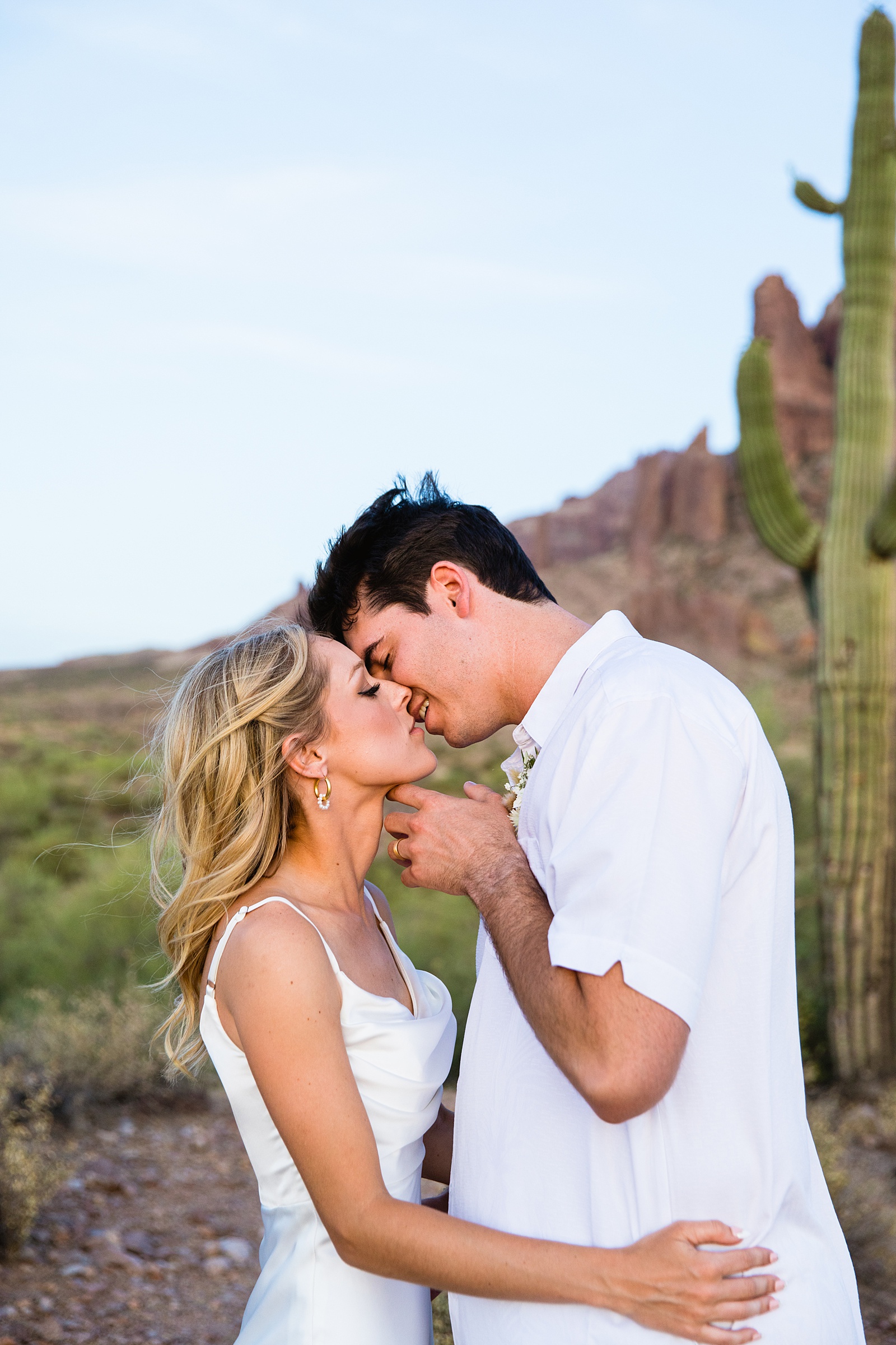 Bride and groom share an intimate moment at their Superstition Mountain Micro wedding by Arizona wedding photographer PMA Photography.