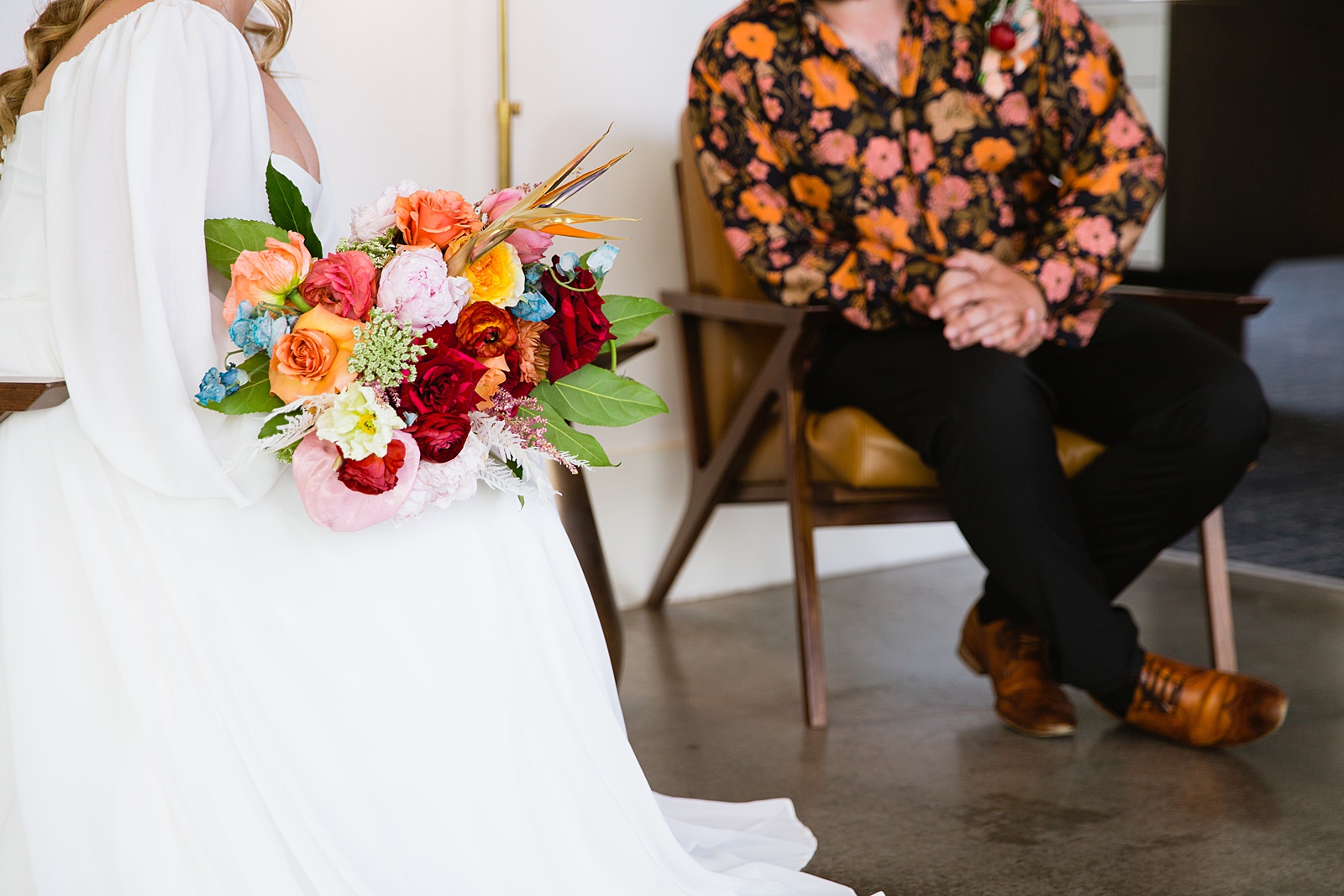 Detail of bride's bouquet while bride and groom talk to each other during their Mountain Shadows Resort wedding by Paradise Valley wedding photographer PMA Photography.