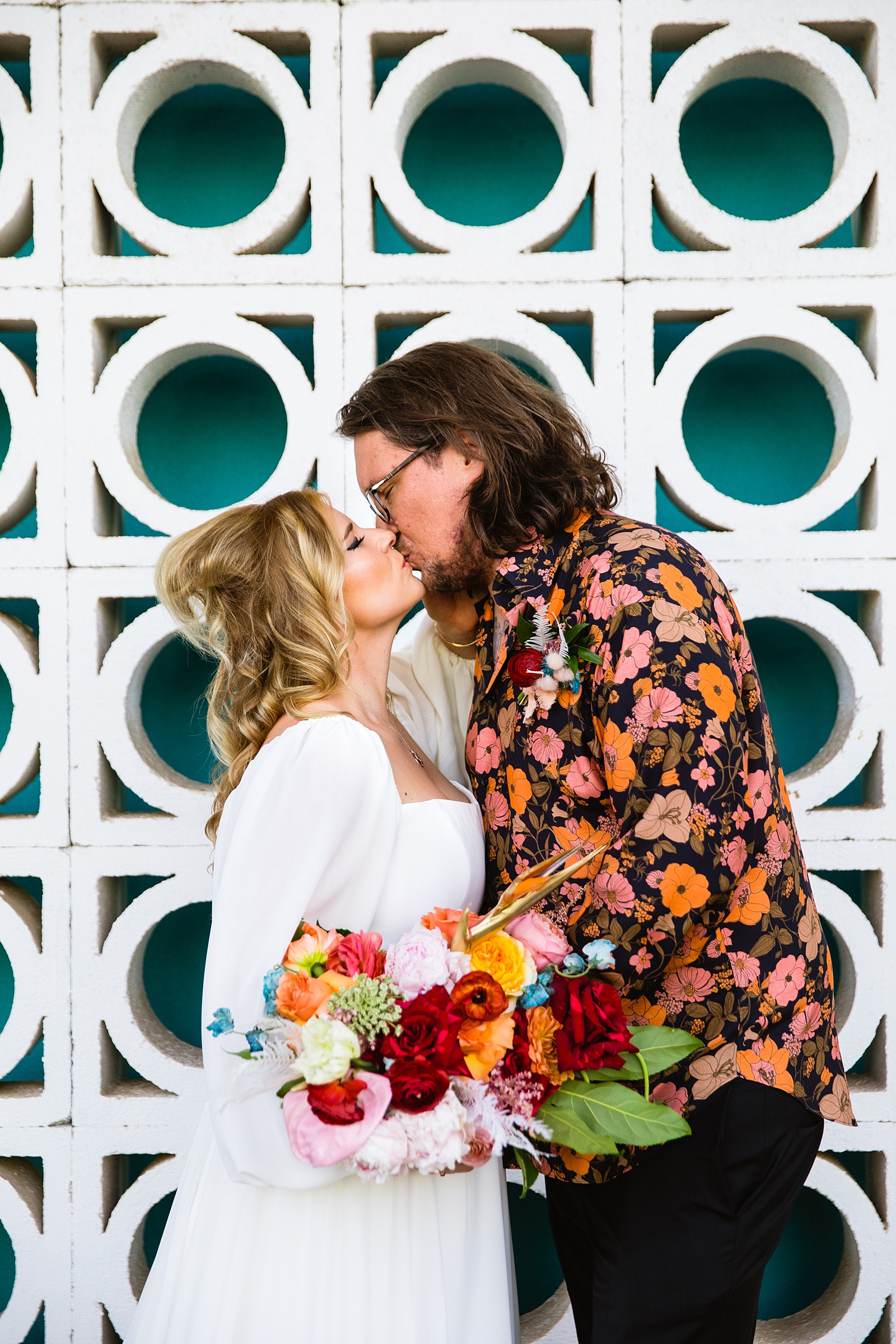 Bride and groom share a kiss during their Mountain Shadows Resort wedding by Paradise Valley wedding photographer PMA Photography.