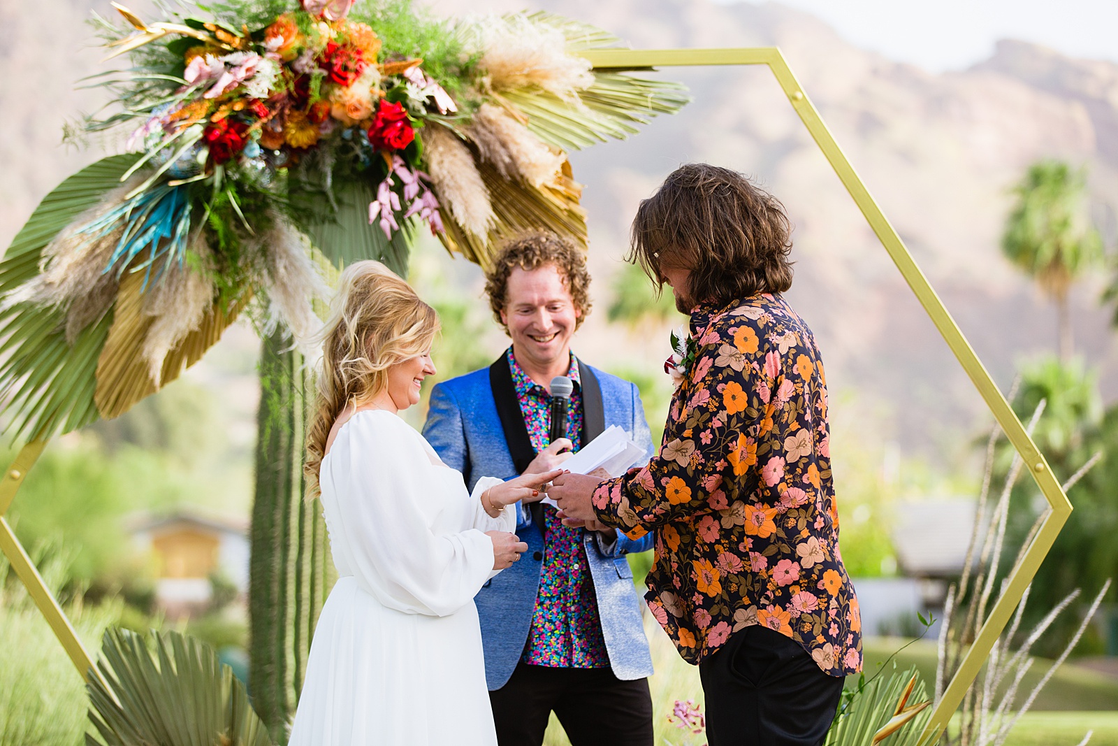 Bride and groom exchange vows during their Mountain Shadows Resort wedding ceremony by Paradise Valley wedding photographer PMA Photography.