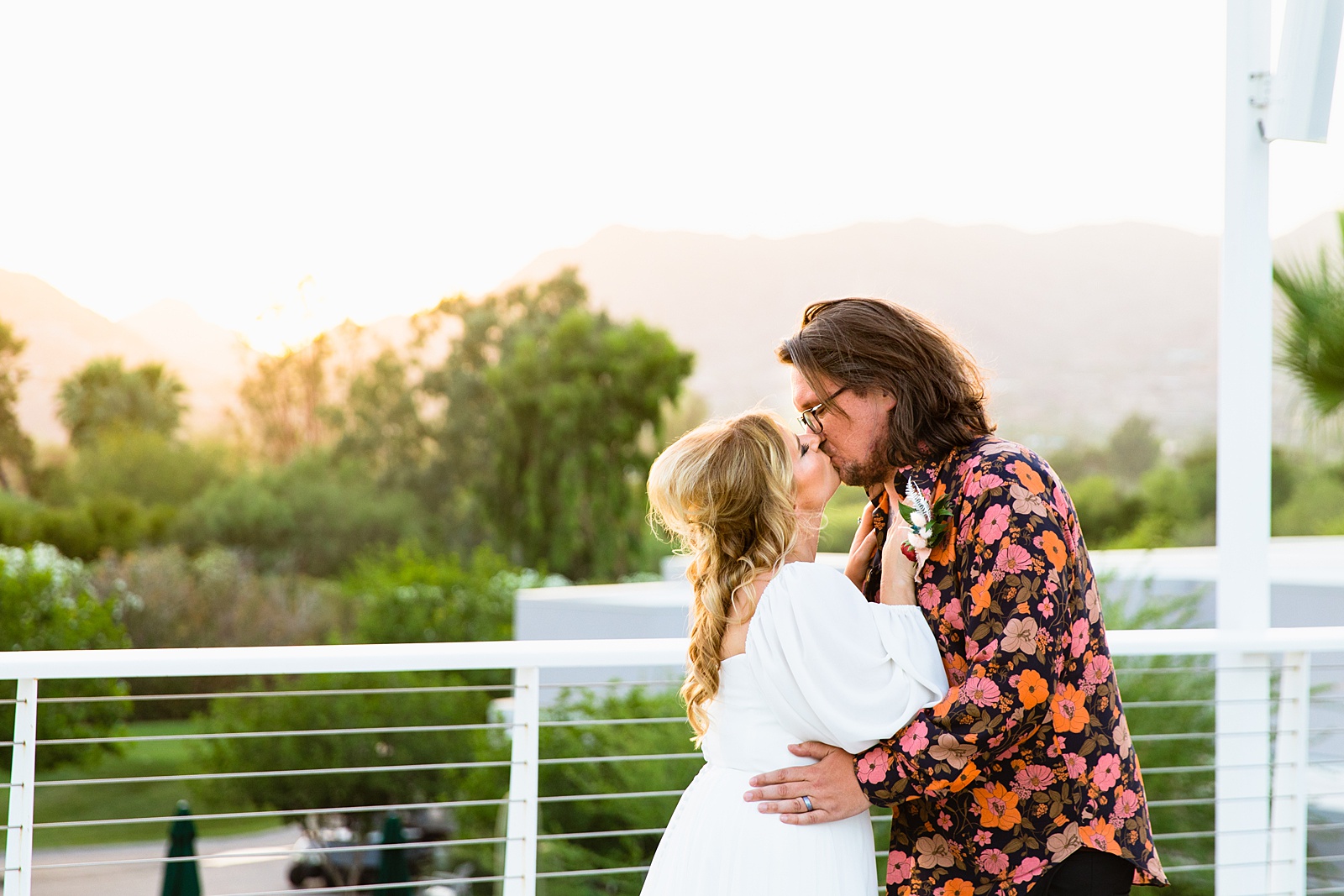 Bride and groom share a kiss during their Mountain Shadows Resort wedding by Arizona wedding photographer PMA Photography.