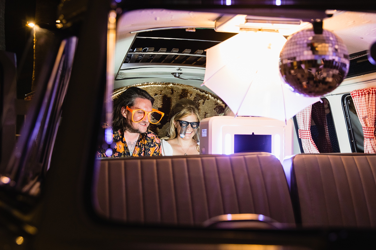 Bride and Groom take photos in retro VW Bus photo booth at Mountain Shadows Resort wedding reception by Paradise Valley wedding photographer PMA Photography