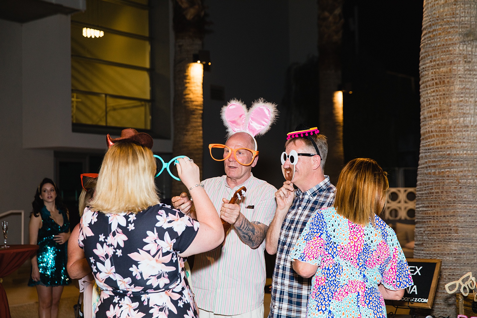 Guests take photos in retro VW Bus photo booth at Mountain Shadows Resort wedding reception by Paradise Valley wedding photographer PMA Photography