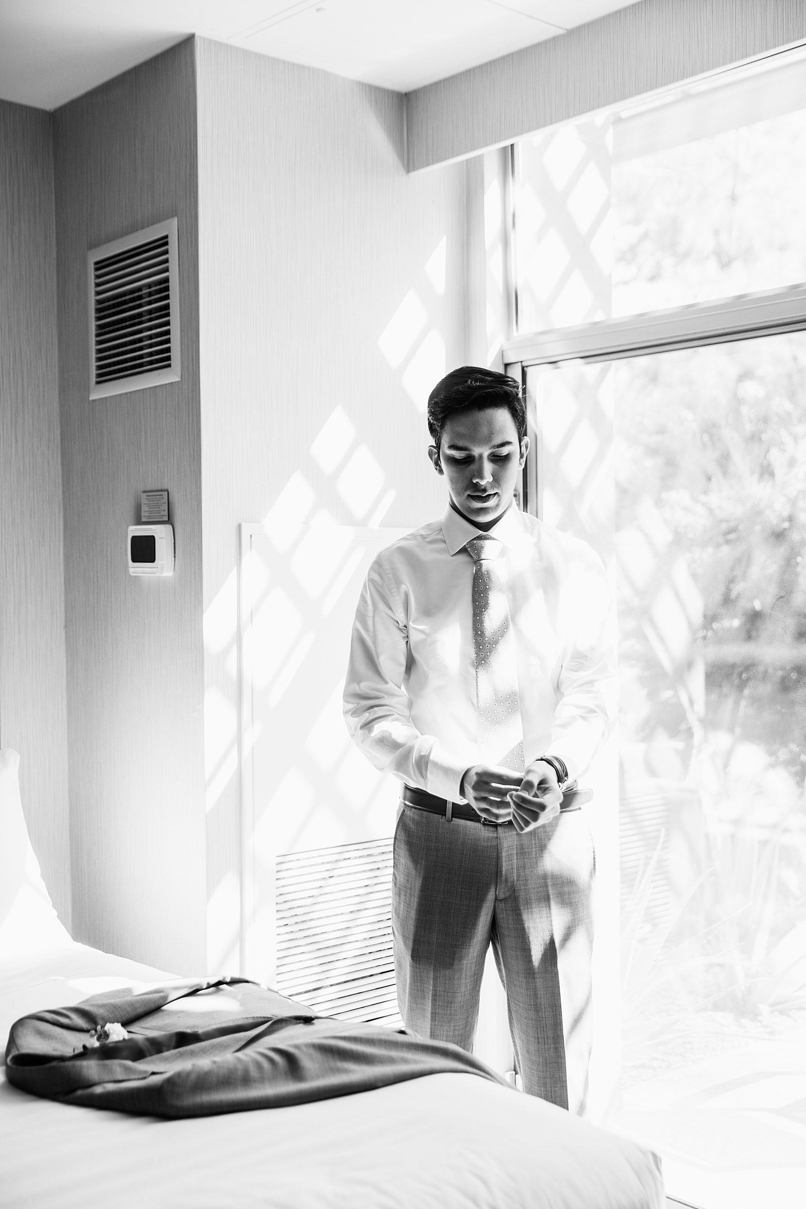 Groom getting ready for his wedding by Phoenix wedding photographers PMA Photography.