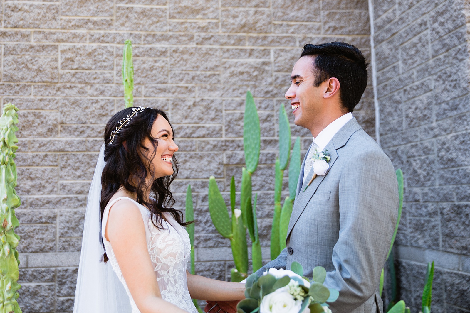 Bride and groom share an intimate moment during their first look at Hyatt Regency Scottsdale Resort & Spa At Gainey Ranch by Phoenix wedding photographer PMA Photography.