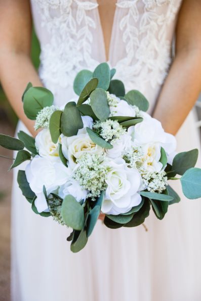 Bride's white and green faux floral bouquet by PMA Photography.