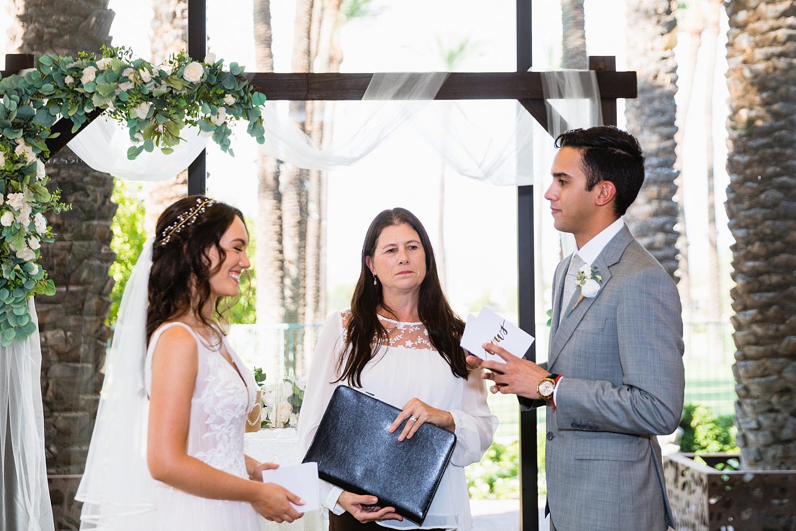 Bride and groom exchange vows during their Hyatt Regency Scottsdale Resort & Spa At Gainey Ranch wedding ceremony by Scottdsale wedding photographer PMA Photography.