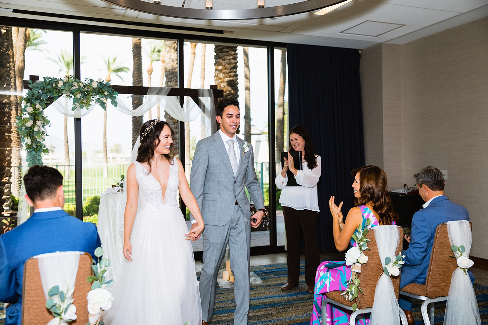 Bride and groom walking down the aisle together as newlyweds by PMA Photography.