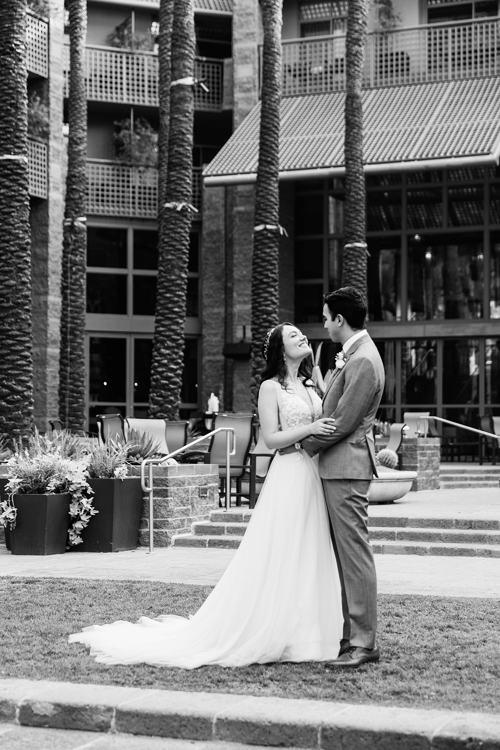 Bride and groom pose during their Hyatt Regency Scottsdale Resort & Spa At Gainey Ranch wedding by Arizona wedding photographer PMA Photography.